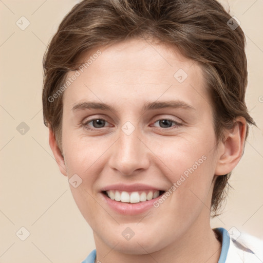 Joyful white young-adult female with short  brown hair and grey eyes