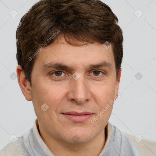 Joyful white adult male with short  brown hair and grey eyes