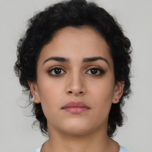 Neutral latino young-adult female with medium  brown hair and brown eyes