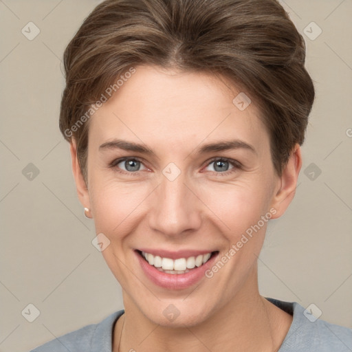 Joyful white young-adult female with short  brown hair and grey eyes