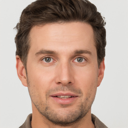 Joyful white young-adult male with short  brown hair and brown eyes