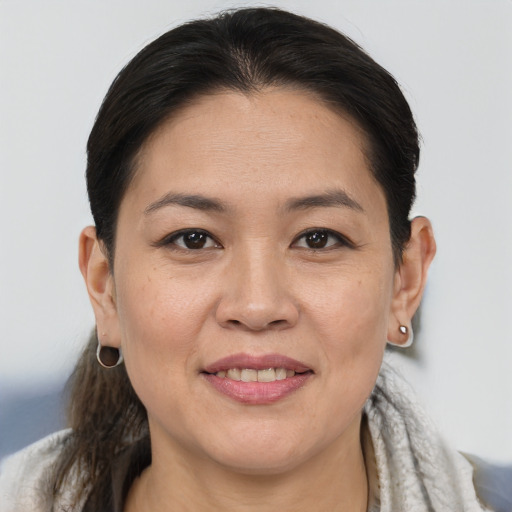 Joyful white adult female with medium  brown hair and brown eyes