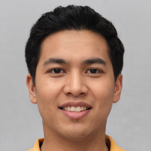 Joyful asian young-adult male with short  black hair and brown eyes