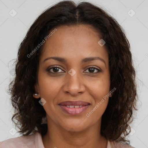Joyful black young-adult female with long  brown hair and brown eyes