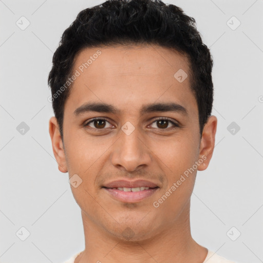 Joyful latino young-adult male with short  black hair and brown eyes