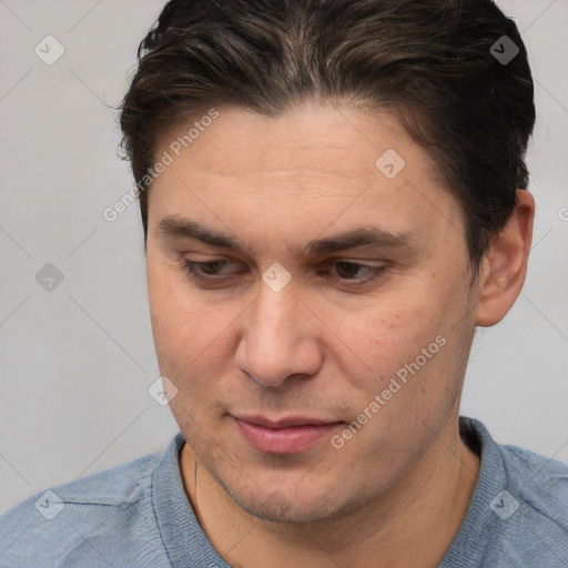 Joyful white adult male with short  brown hair and brown eyes