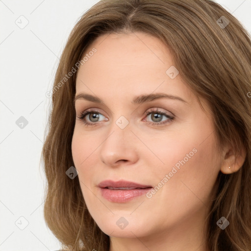 Joyful white young-adult female with long  brown hair and green eyes