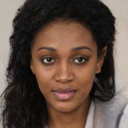 Joyful black young-adult female with long  brown hair and brown eyes