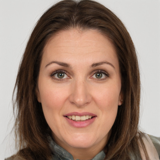 Joyful white adult female with long  brown hair and brown eyes