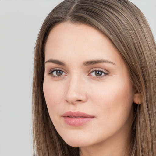 Neutral white young-adult female with long  brown hair and brown eyes