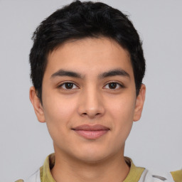 Joyful asian young-adult male with short  black hair and brown eyes