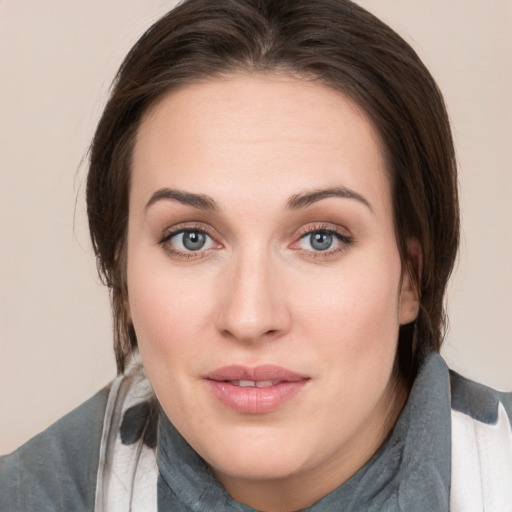 Joyful white young-adult female with medium  brown hair and grey eyes