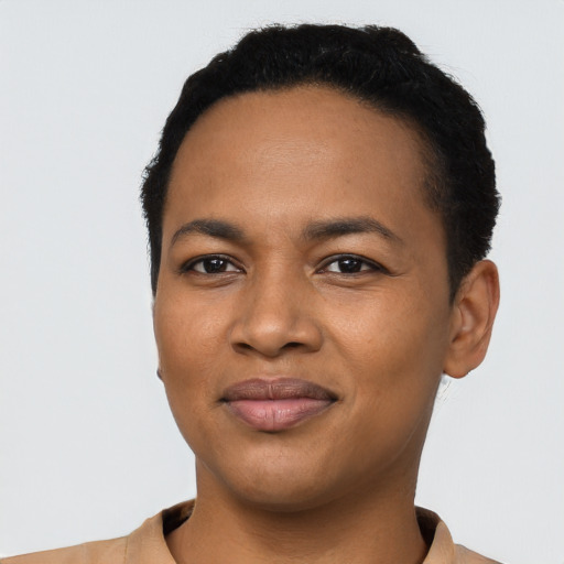 Joyful black young-adult female with short  black hair and brown eyes
