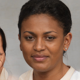 Joyful black young-adult female with medium  brown hair and brown eyes