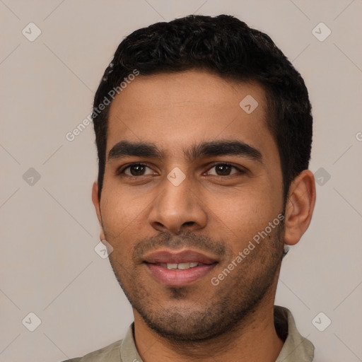 Joyful latino young-adult male with short  black hair and brown eyes