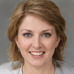 Joyful white young-adult female with medium  brown hair and blue eyes