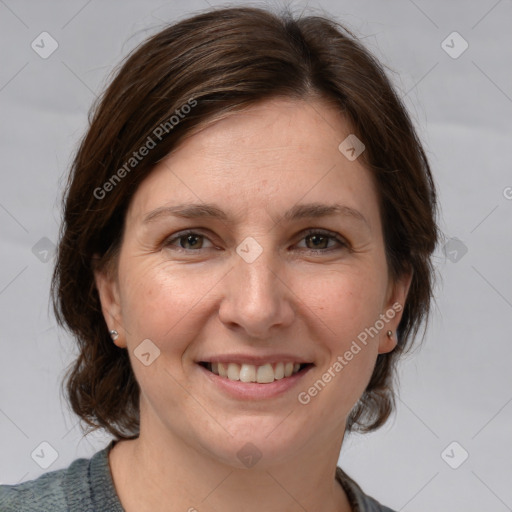 Joyful white adult female with medium  brown hair and grey eyes