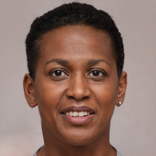 Joyful black young-adult female with short  brown hair and brown eyes