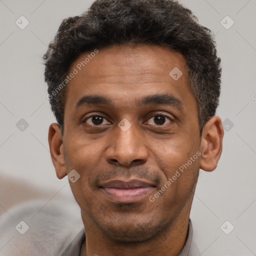 Joyful latino adult male with short  black hair and brown eyes