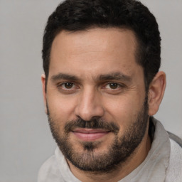 Joyful white adult male with short  brown hair and brown eyes