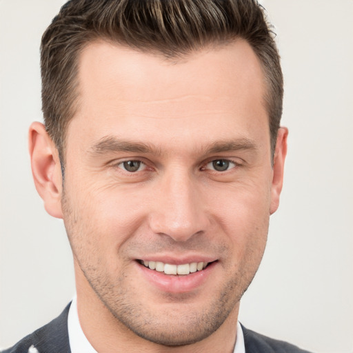 Joyful white young-adult male with short  brown hair and brown eyes