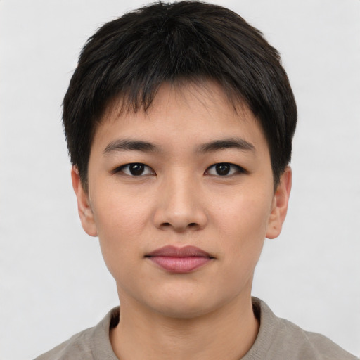 Joyful asian young-adult male with short  brown hair and brown eyes