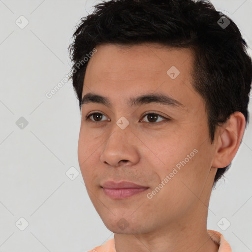 Joyful white young-adult male with short  black hair and brown eyes