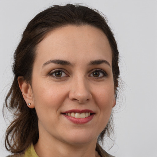 Joyful white adult female with medium  brown hair and brown eyes