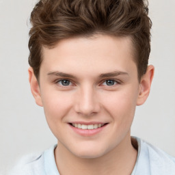 Joyful white child male with short  brown hair and grey eyes