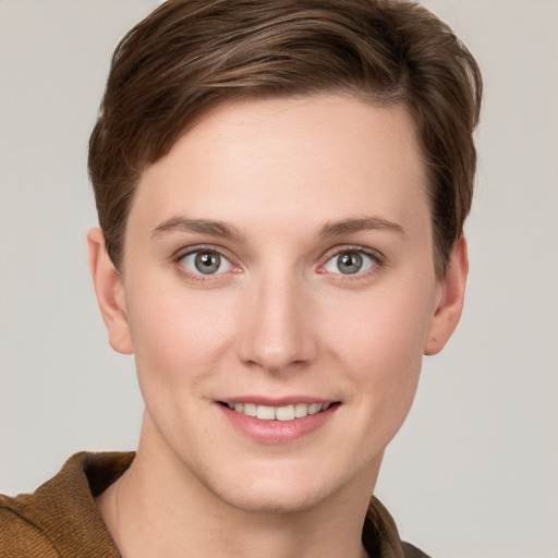 Joyful white young-adult female with short  brown hair and grey eyes