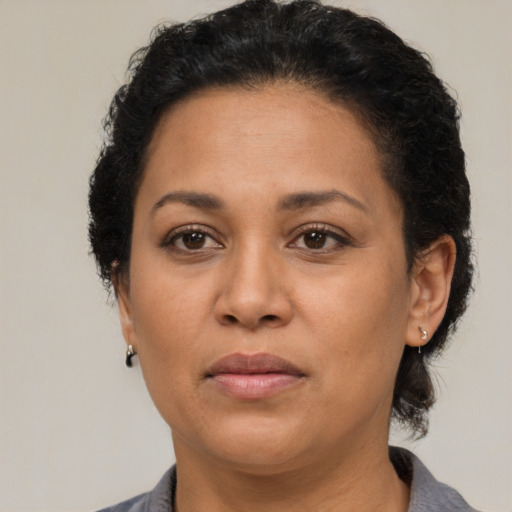 Neutral latino adult female with short  brown hair and brown eyes