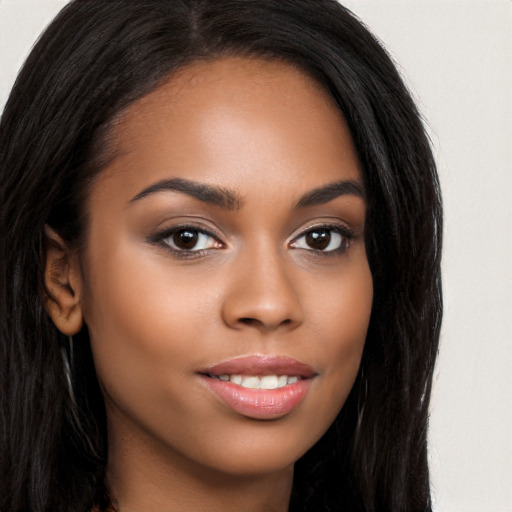 Joyful latino young-adult female with long  brown hair and brown eyes