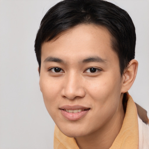 Joyful asian young-adult male with short  brown hair and brown eyes