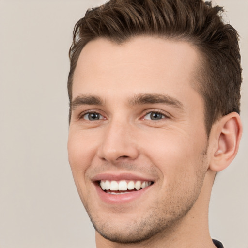 Joyful white young-adult male with short  brown hair and brown eyes