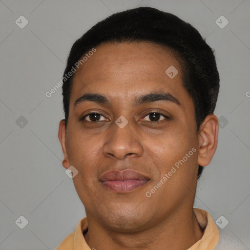 Joyful black young-adult male with short  brown hair and brown eyes