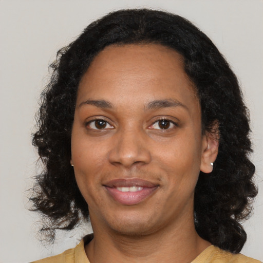 Joyful black adult female with medium  black hair and brown eyes