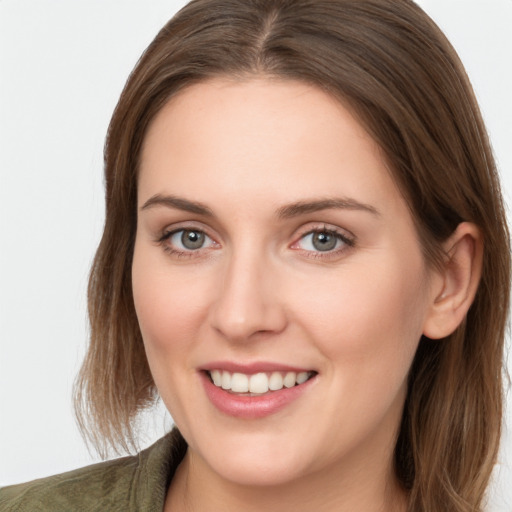 Joyful white young-adult female with long  brown hair and grey eyes