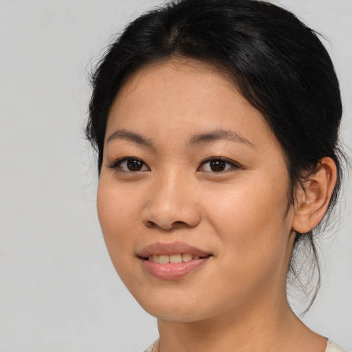 Joyful asian young-adult female with medium  black hair and brown eyes