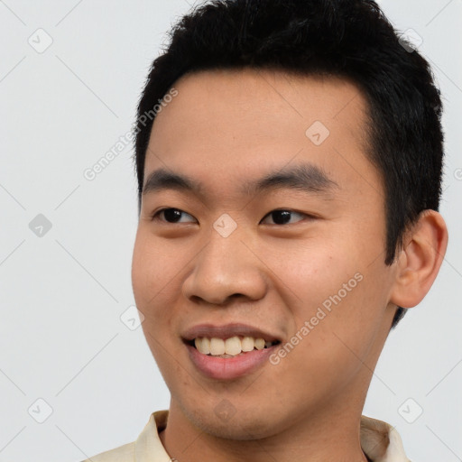 Joyful asian young-adult male with short  black hair and brown eyes