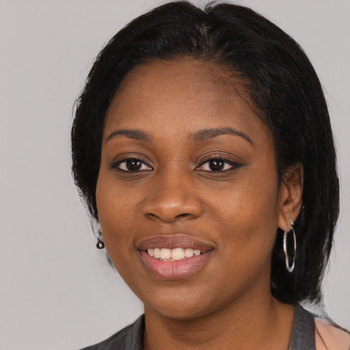 Joyful black young-adult female with medium  black hair and brown eyes