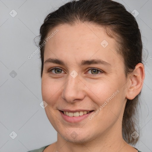 Joyful white young-adult female with short  brown hair and brown eyes