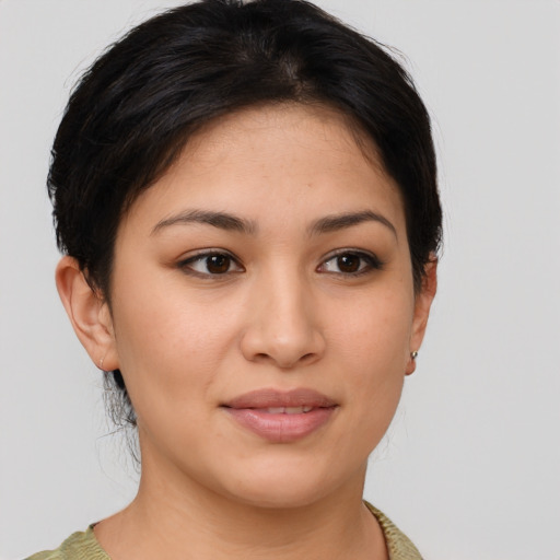 Joyful latino young-adult female with medium  brown hair and brown eyes