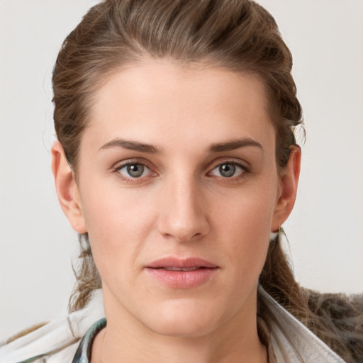 Joyful white young-adult female with medium  brown hair and grey eyes