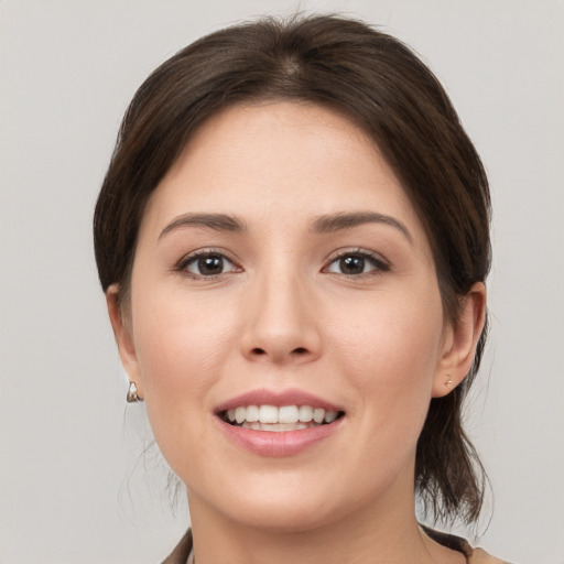 Joyful white young-adult female with medium  brown hair and brown eyes