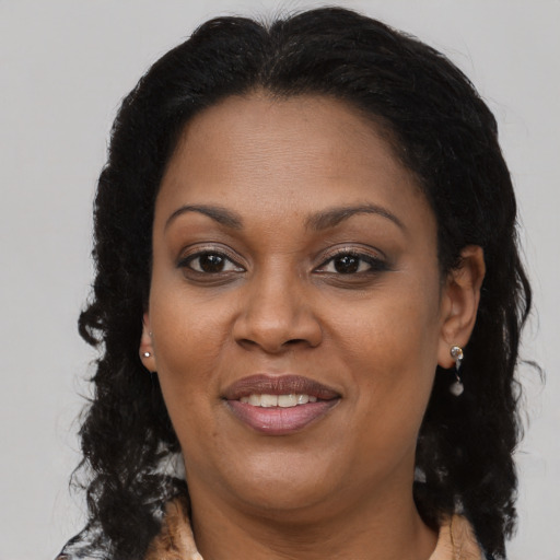 Joyful black adult female with medium  brown hair and brown eyes