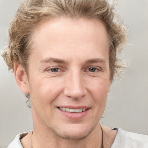 Joyful white adult male with short  brown hair and grey eyes