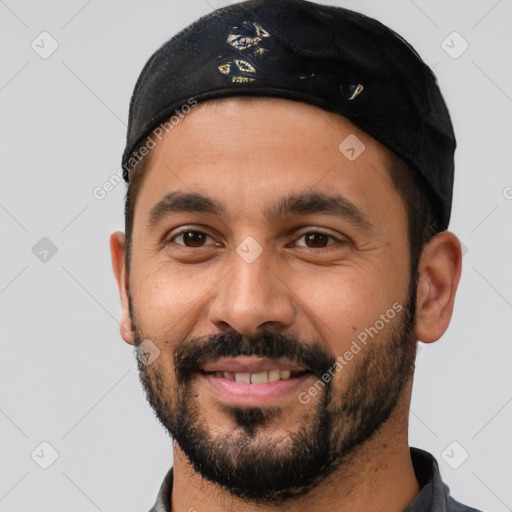 Joyful latino young-adult male with short  black hair and brown eyes