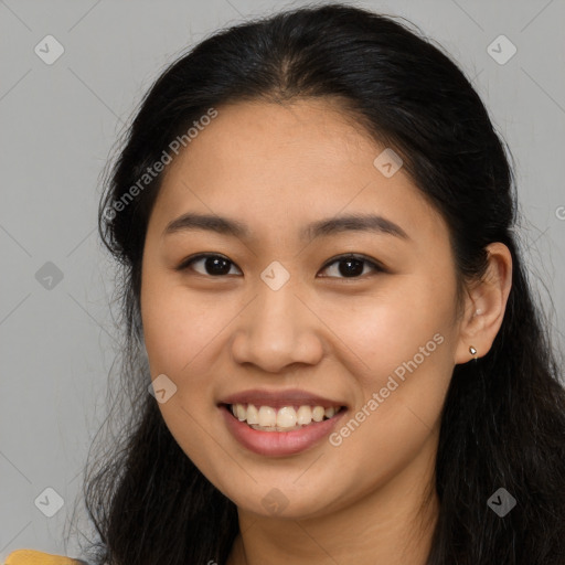 Joyful latino young-adult female with long  brown hair and brown eyes