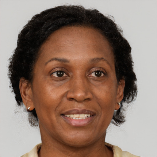 Joyful black adult female with short  brown hair and brown eyes