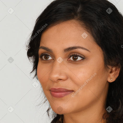 Joyful latino young-adult female with long  brown hair and brown eyes